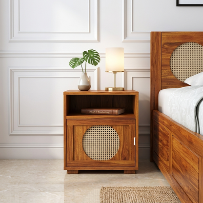 The RJ Art Sheesham Wood Bedside Table with Cane Panel Door and Open Shelf Storage