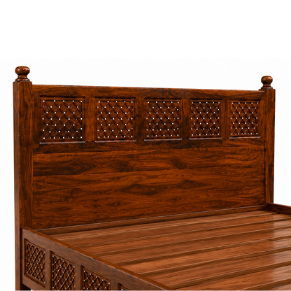 The RJ Art premium Sheesham wood king size bed with decorative carved headboard and footboard in a rich walnut finish.